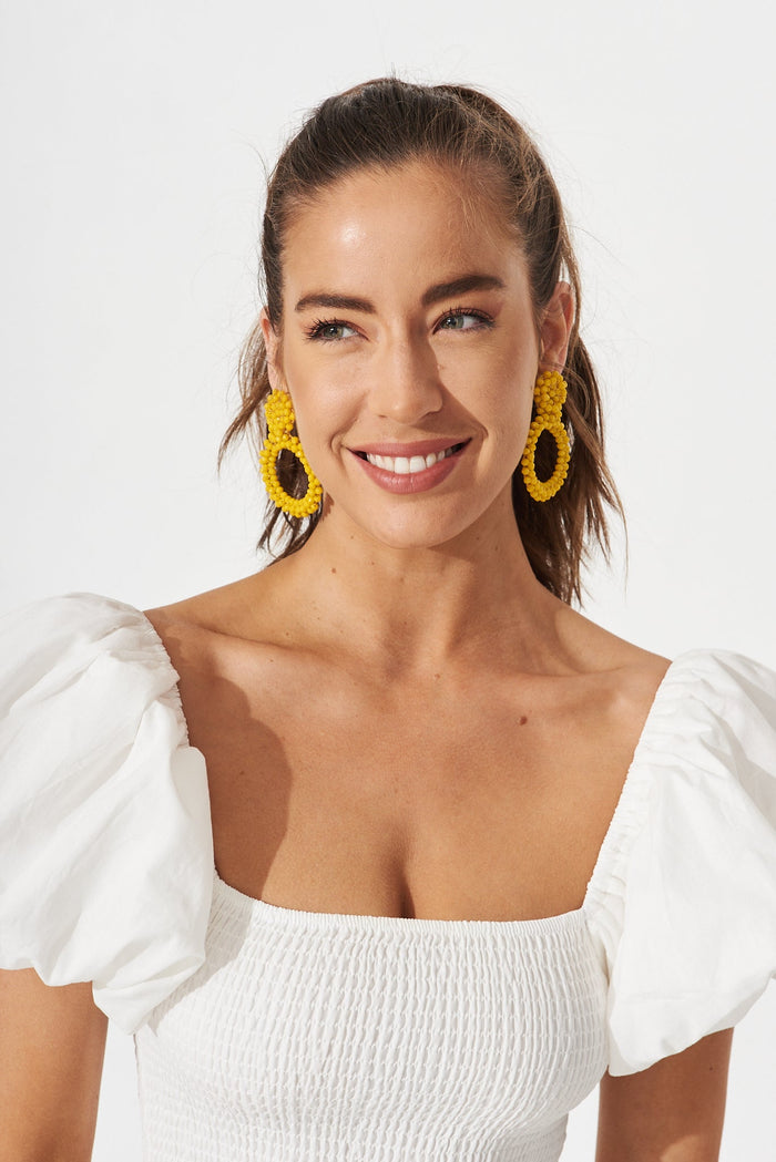 August + Delilah Poarch Bead Earrings In Mustard - front