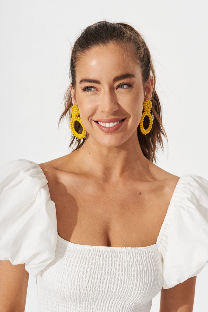 August + Delilah Poarch Bead Earrings In Mustard - front