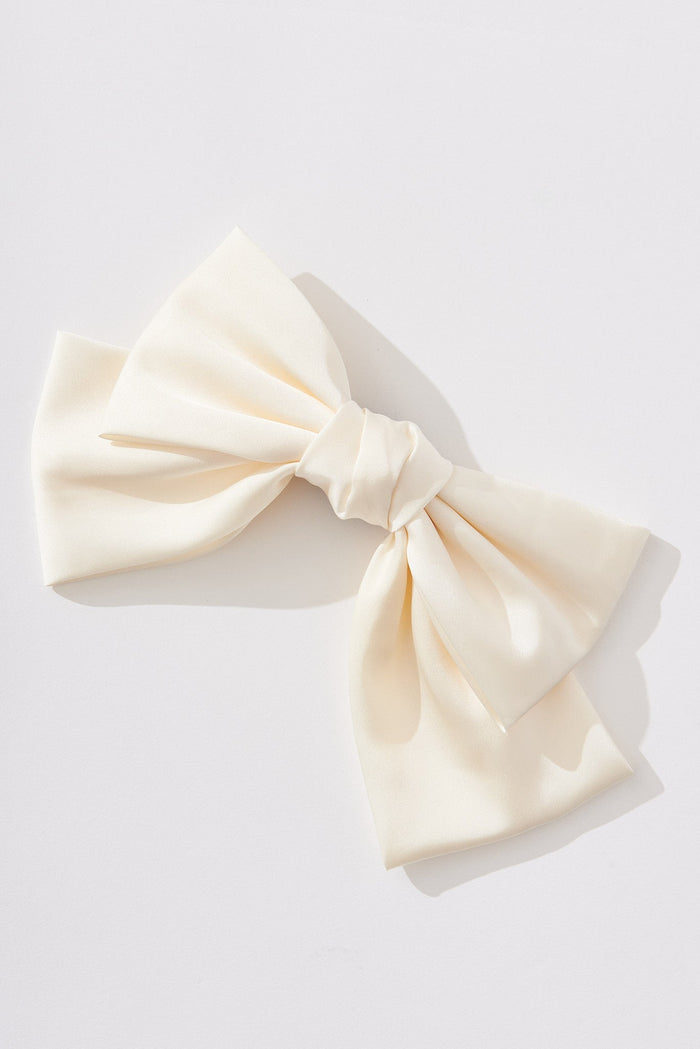 August + Delilah Santana Oversized Bow Hair Clip In Beige Satin - front flatlay