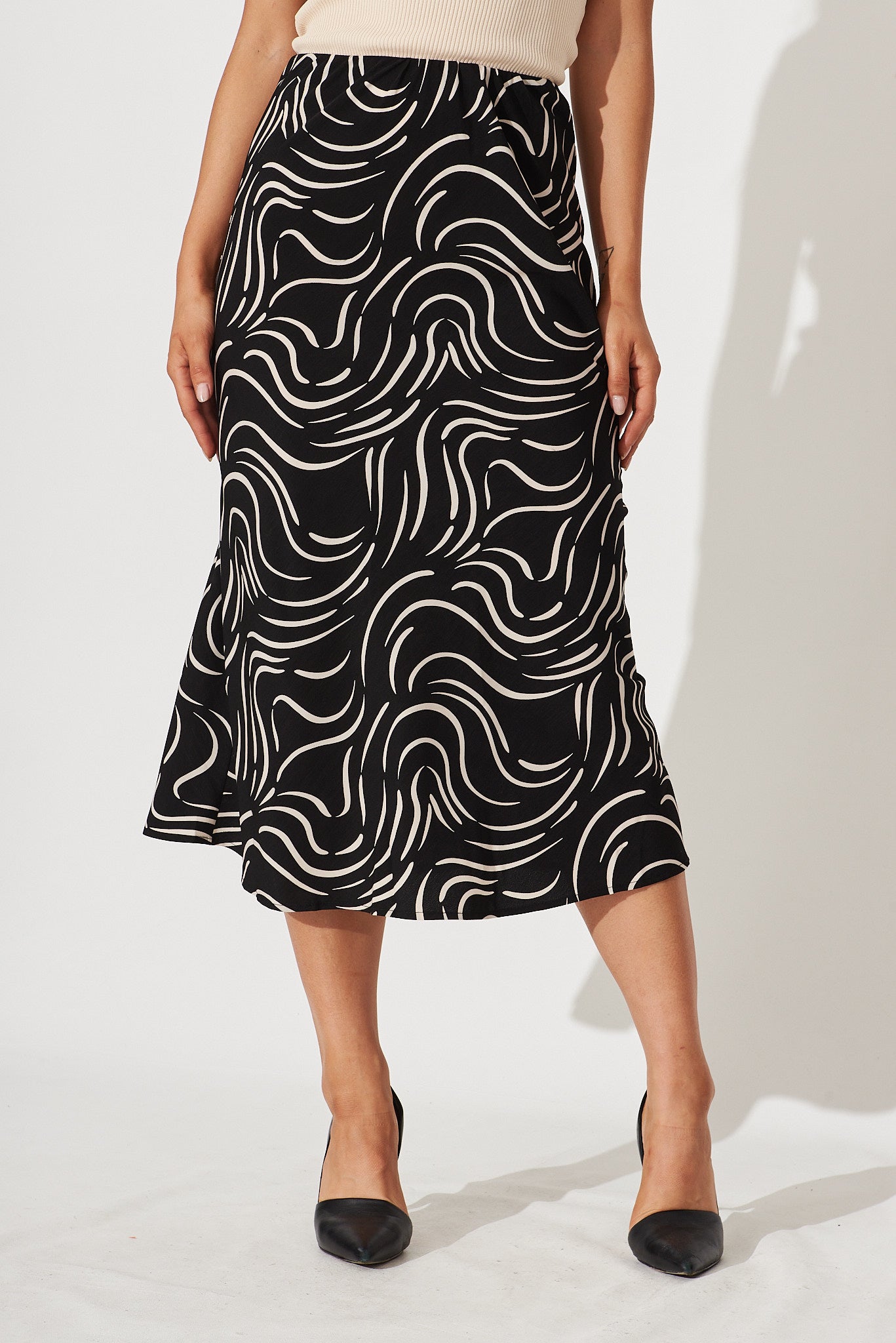 Monica Midi Skirt In Black With Sand Swirl Print - front